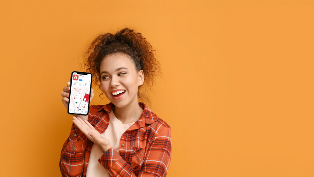 Mulher segurando um secular indicando para o app da APOIA.se